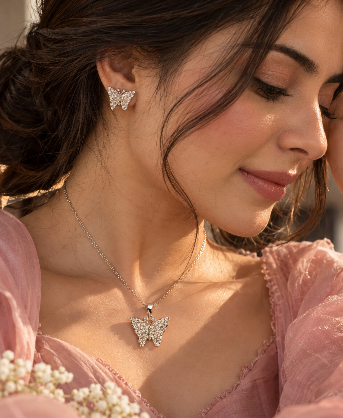 Butterfly pendant necklace and matching earrings on woman
