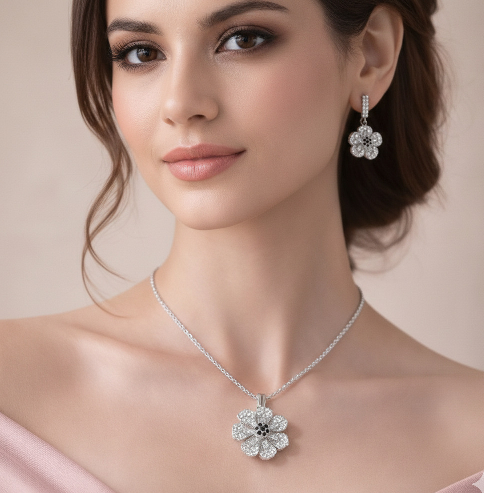Woman wearing a silver floral necklace and earrings against a beige background