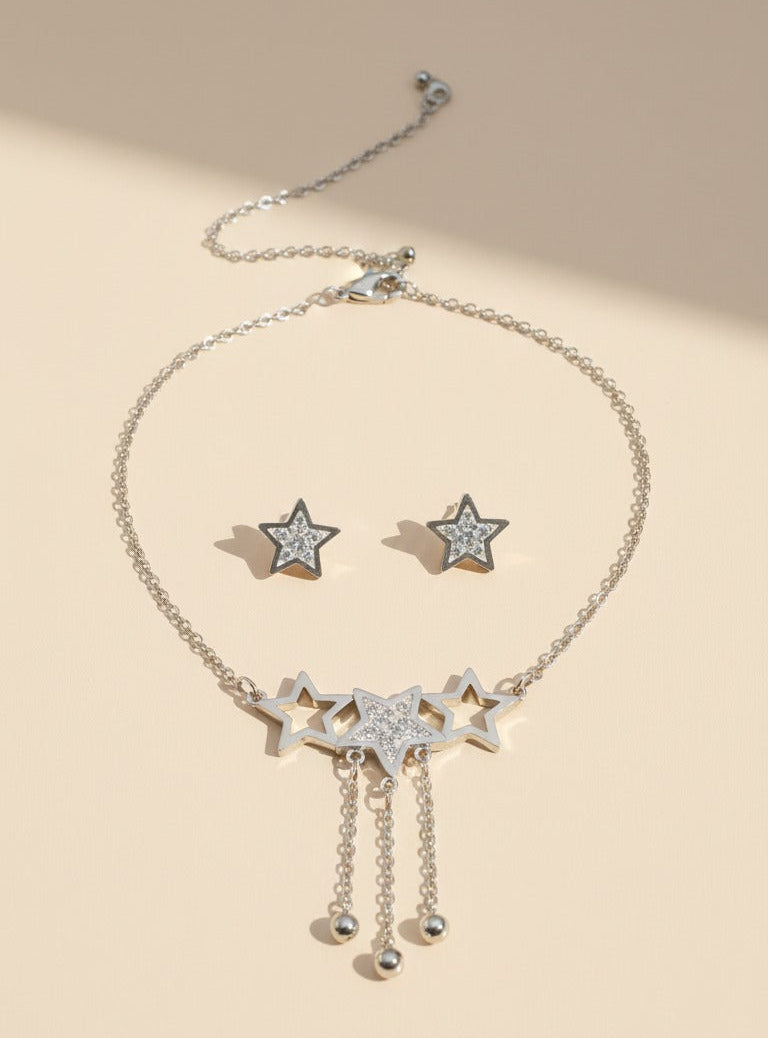 Star-themed necklace and earrings on a beige background